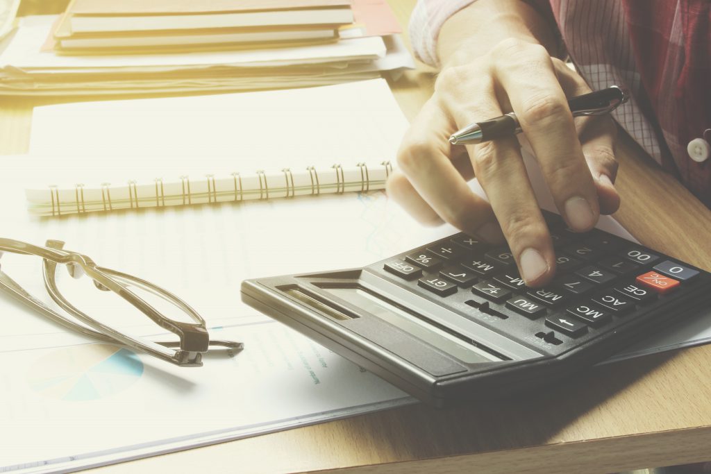 Hand use calculator on the office desk  investment and property
